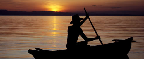 A lone fisherman paddles homewards on Lake Malawi 